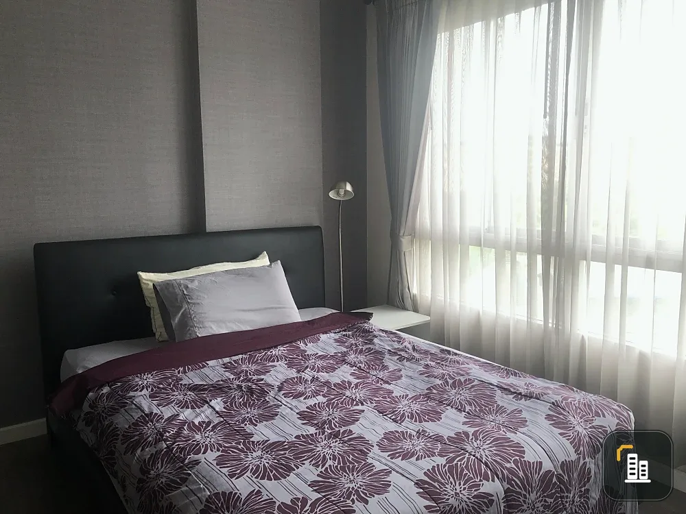 For sale: D Condo Campus Rangsit Phase 1. Bedroom has double-layered curtains that can be pulled closed to block UV light. Wallpaper on the walls. A h