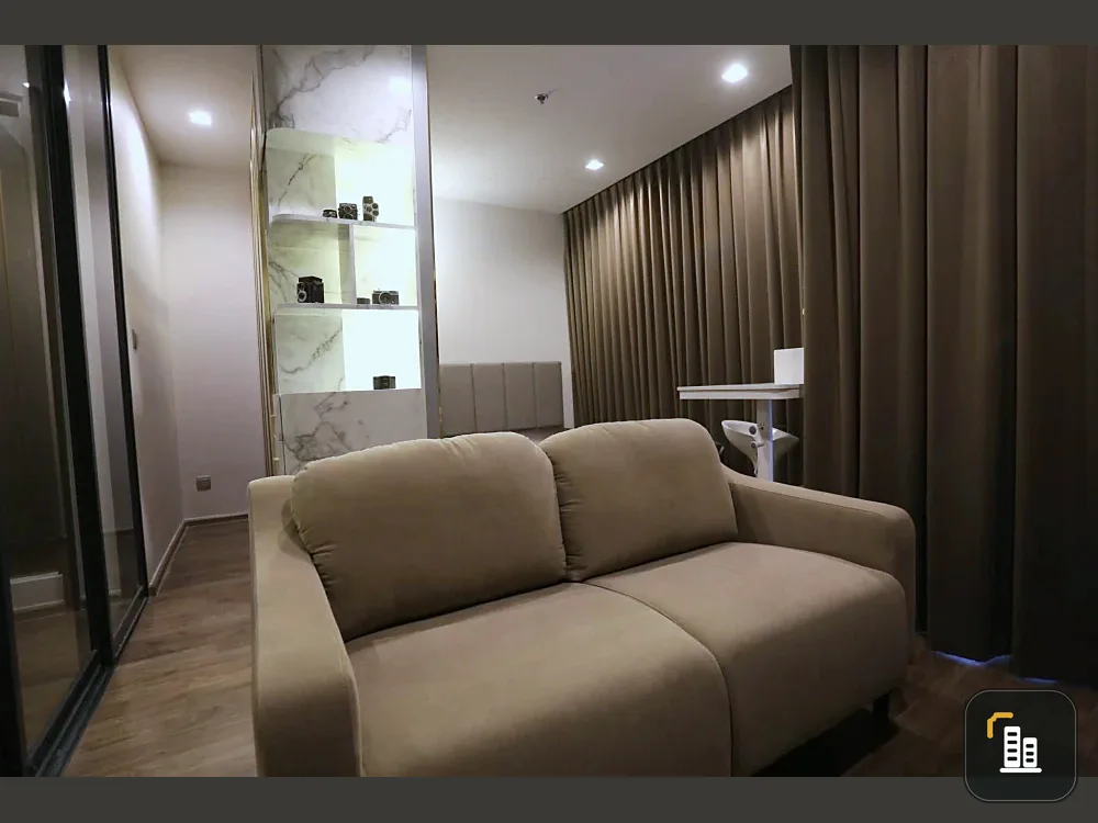 For rent: Life Ladprao Valley, 32nd floor, stunning unobstructed city view. Features include a large 58-inch wall-mounted TV and a built-in mini-walk