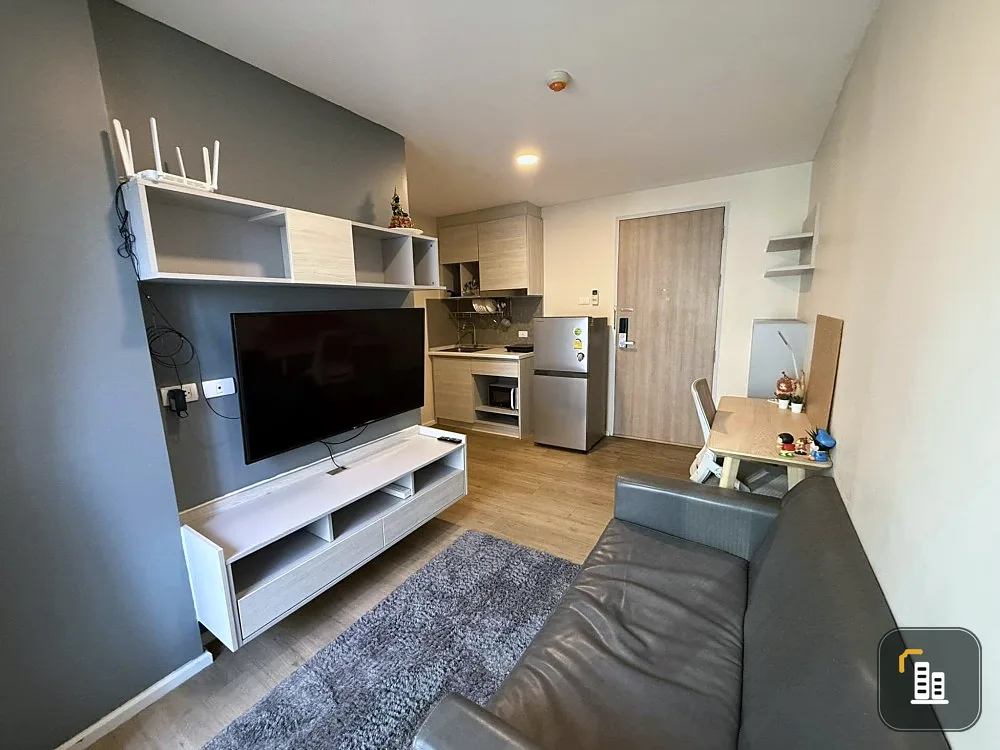 For sale: Ril Condo Rangsit, a room decorated in a chic gray tone, fully furnished, including a large-screen TV. Interested? Reserve now!